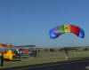 Another skydiver lands.